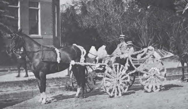 Harry Kanner rides with son Aaron in parade 1912